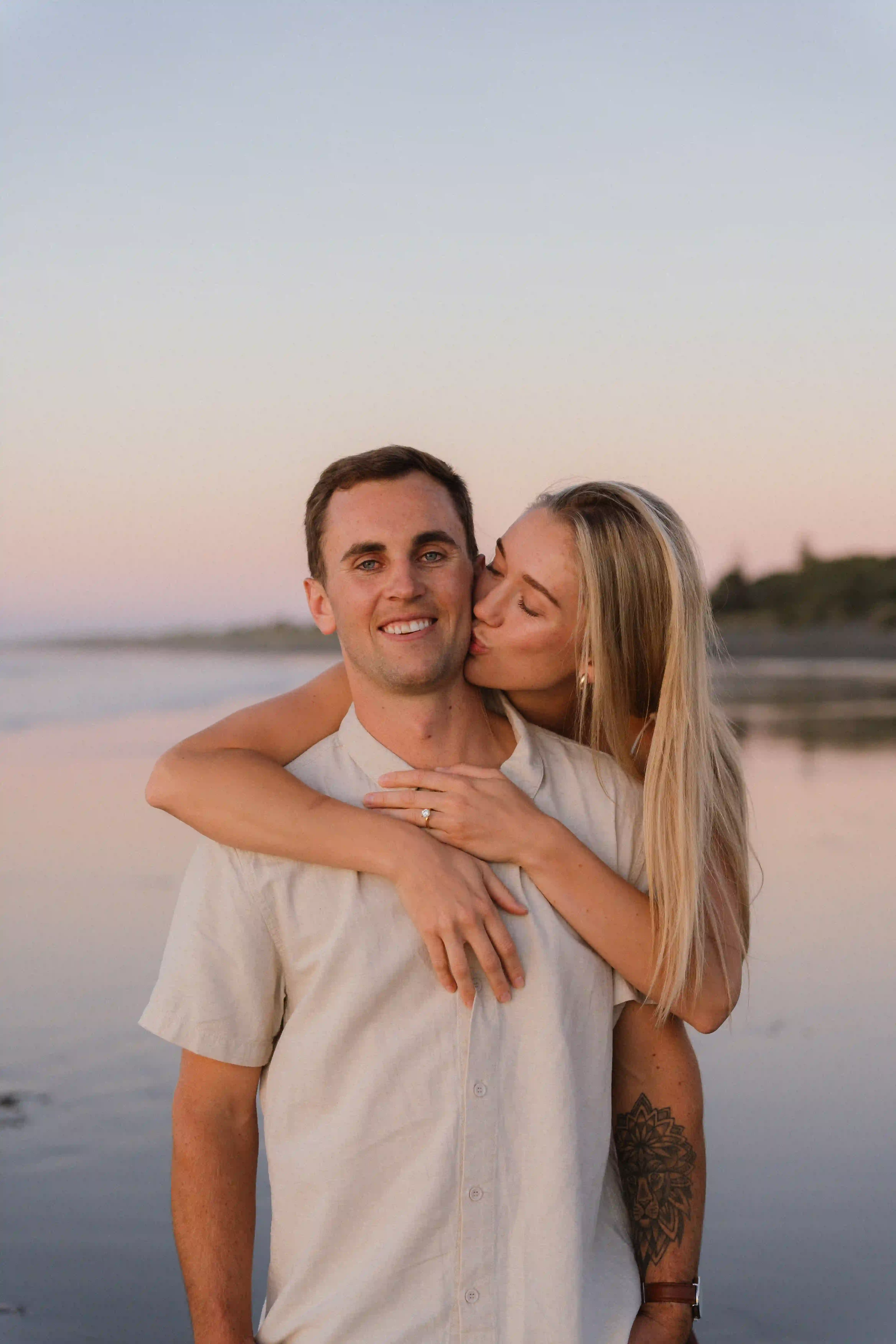 Wedding photography New Plymouth - couple holding hands as waves roll in