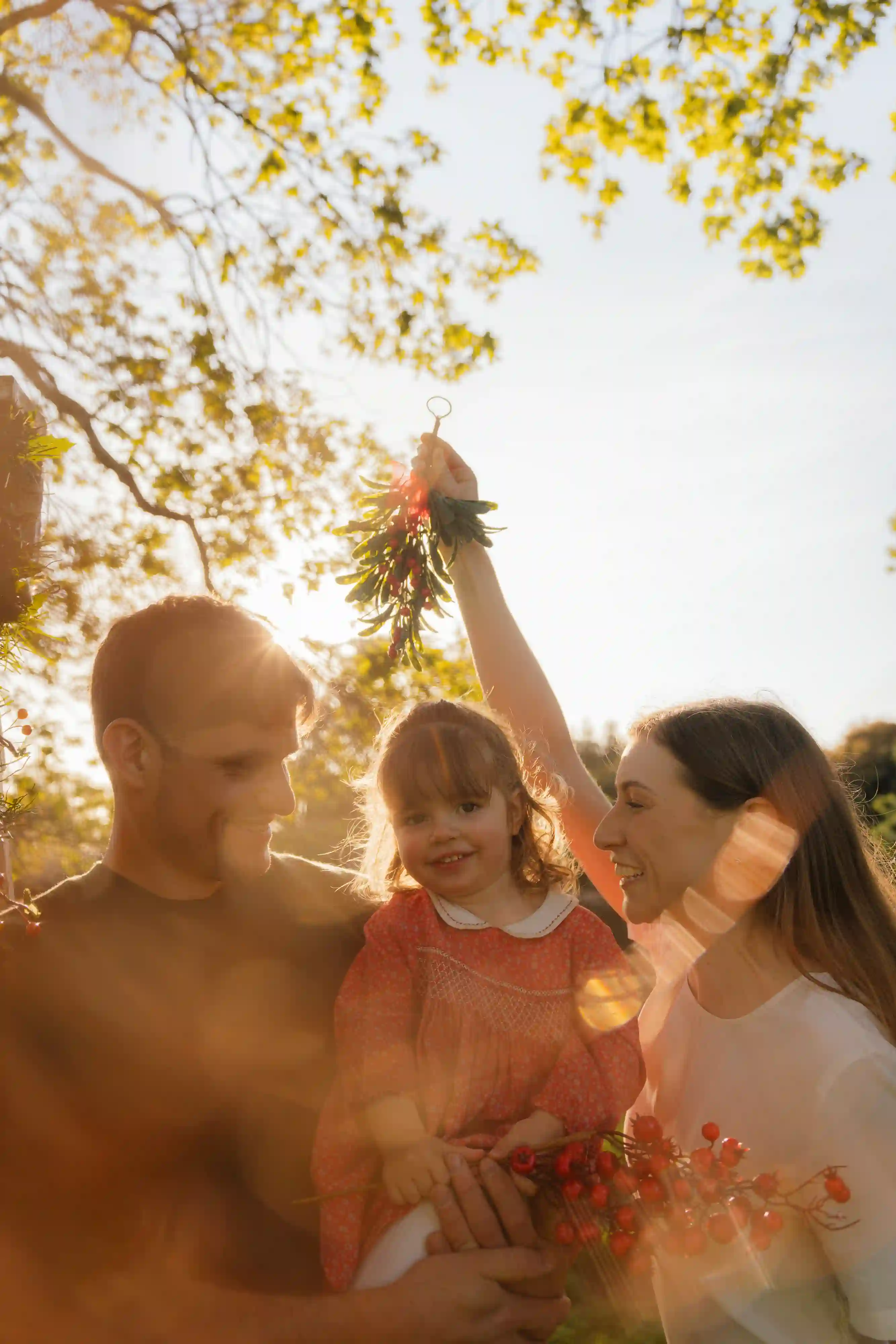 Family photography New Plymouth - parents holding their child during a cosy Christmas mini shoot